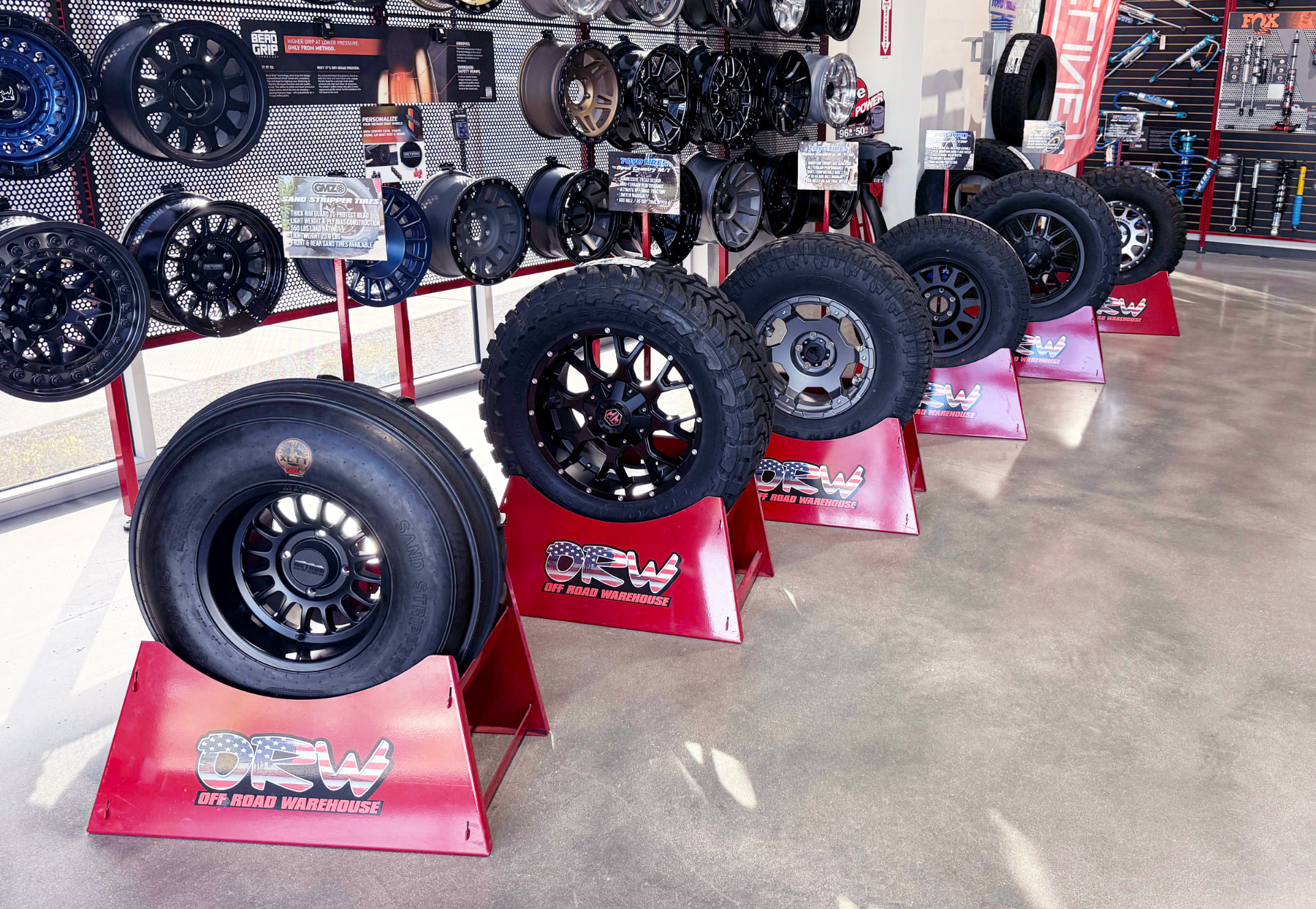Row of branded product display stands receding through a retail showroom
