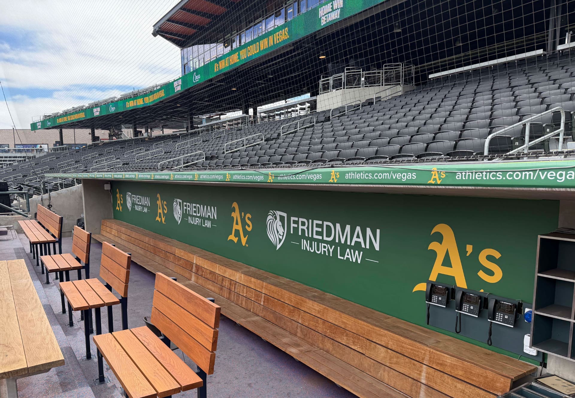 Stadium seating and dugout integrated with continuous branded graphics