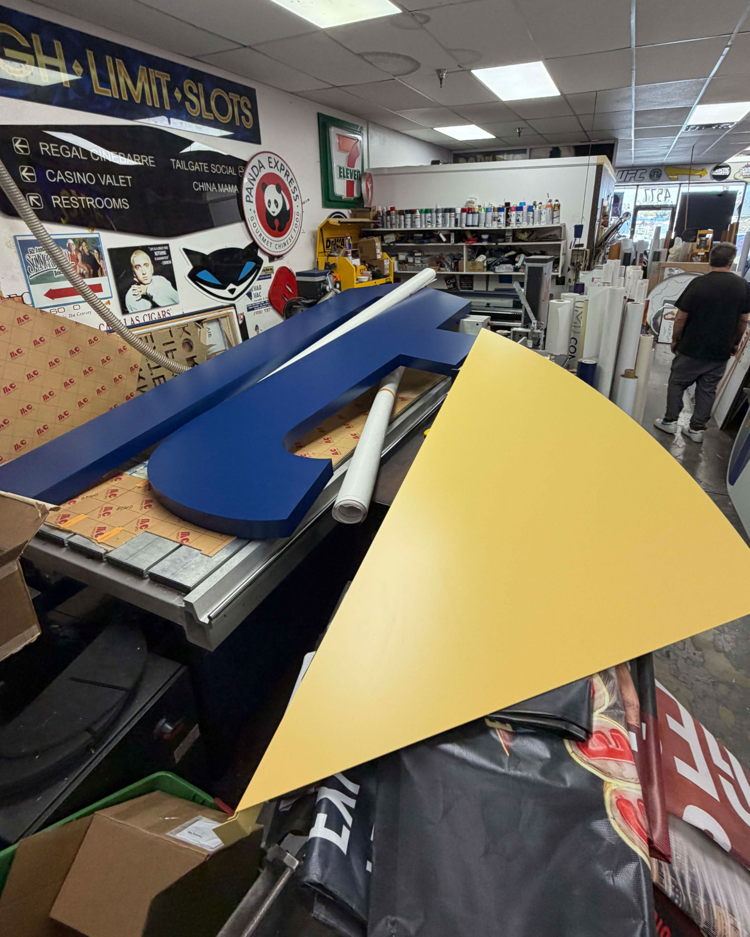 Dimensional letterforms and cut panels on a workshop table
