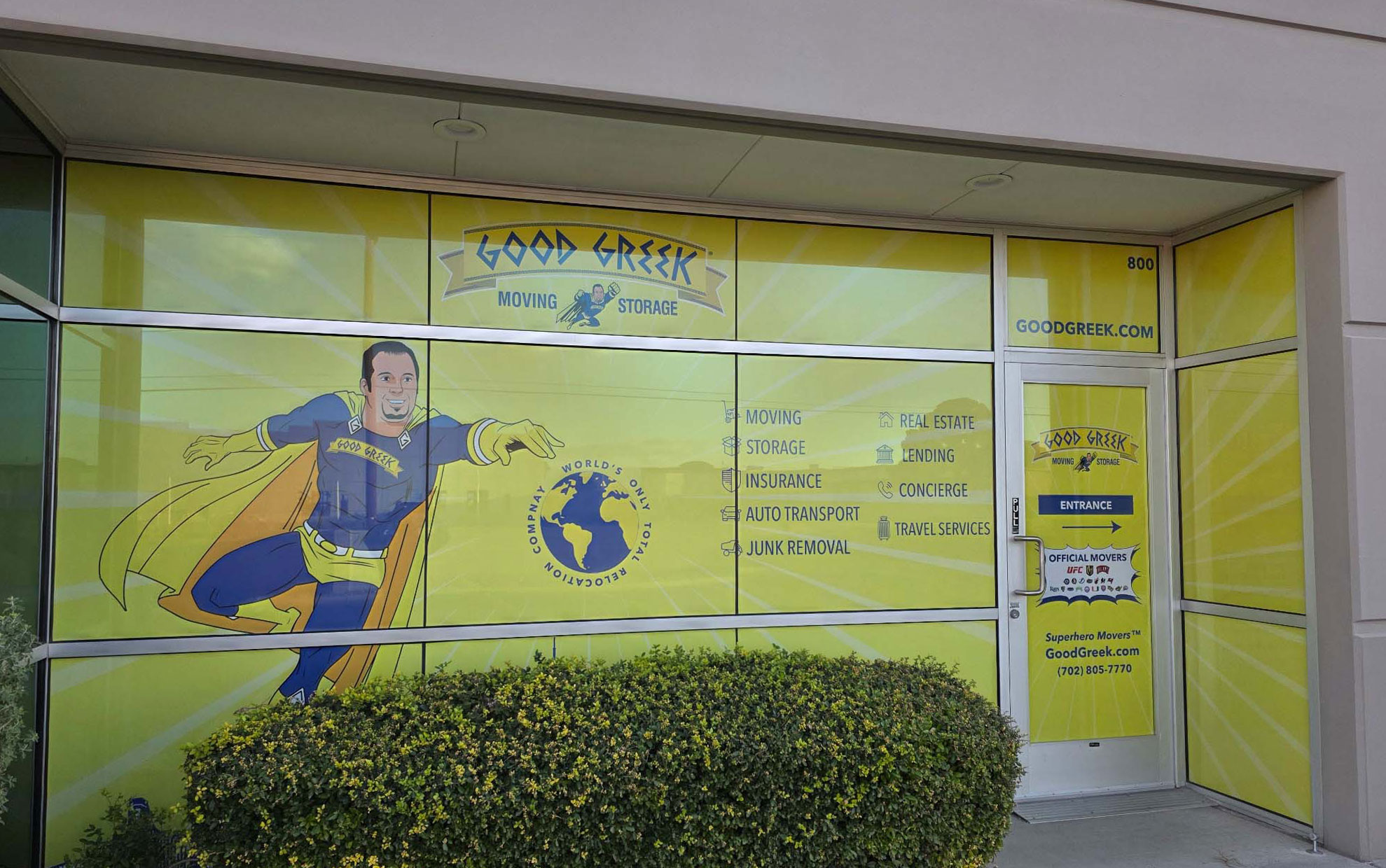 Storefront windows and entrance door covered in coordinated illustrated graphics