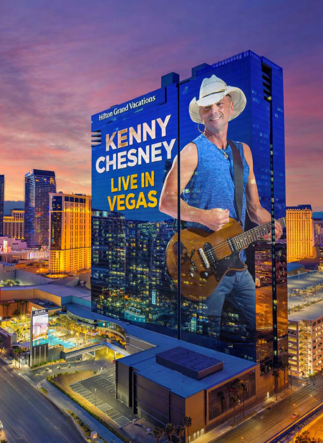 Tall hotel tower covered top to bottom in a printed concert graphic