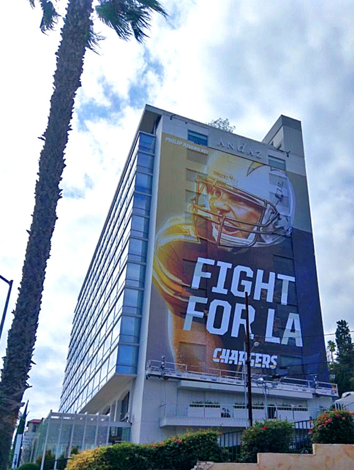 Large-format football graphics applied across a hotel facade